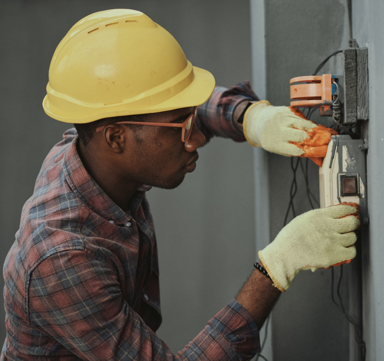 Construction worker installing electrical components